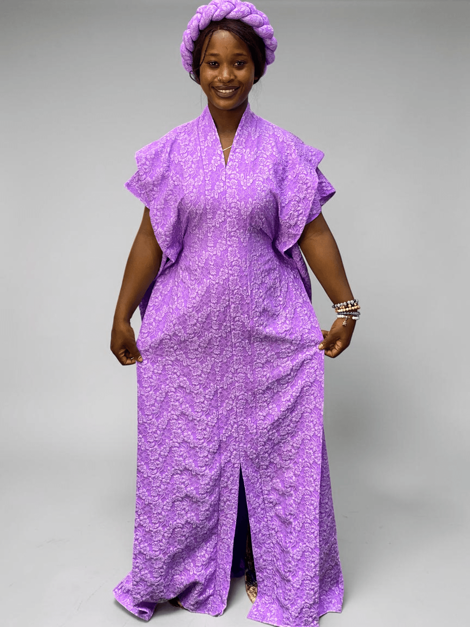 Lavender purple 3D floral gown with raised floral texture and adjustable waist ties on grey studio background