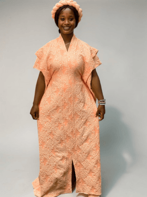 Peach 3D floral gown with raised floral texture and adjustable waist ties on grey studio background