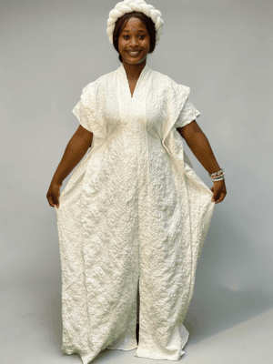 Ivory 3D floral gown with raised floral texture and adjustable waist ties on grey studio background