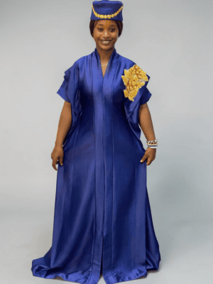 Royal blue satin boubou gown with embellished shoulder detail and adjustable waist ties on grey studio background