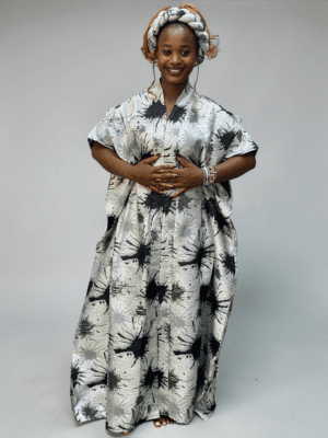 Silver and black brocade gown with ink-inspired woven pattern and adjustable waist ties on grey studio background