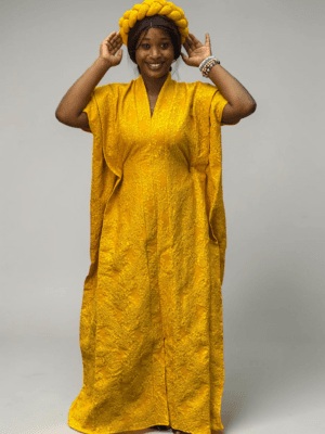 Marigold yellow 3D floral gown with raised floral texture and adjustable waist ties on grey studio background
