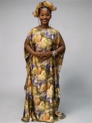 Beige gold and purple marble floral printed satin kaftan with adjustable waist ties on grey studio background
