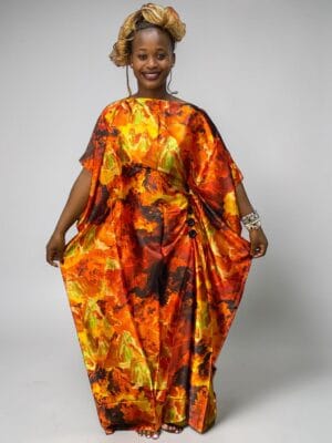 Orange and red floral printed satin kaftan with adjustable waist ties on a grey studio background