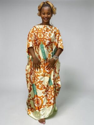Ivory and orange baroque printed satin kaftan with adjustable waist ties on a grey studio background