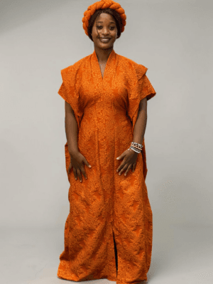 Tangerine orange 3D floral gown with raised floral texture and adjustable waist ties on grey studio background