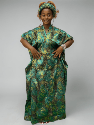 Teal green and gold floral brocade gown with woven textured pattern and adjustable waist ties on grey studio background