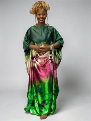 Emerald and blush printed satin kaftan with adjustable waist ties on a grey studio background