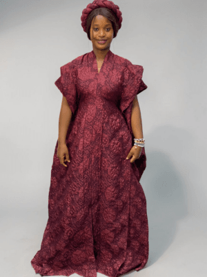 Burgundy 3D floral gown with raised floral texture and adjustable waist ties on grey studio background