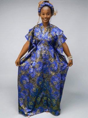 Cobalt blue floral brocade gown with woven textured pattern and adjustable waist ties on grey studio background