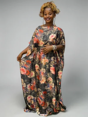 Charcoal floral printed satin kaftan with adjustable waist ties on a grey studio background